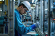 © Alina - Worker assembles mobile phones at manufacturing company