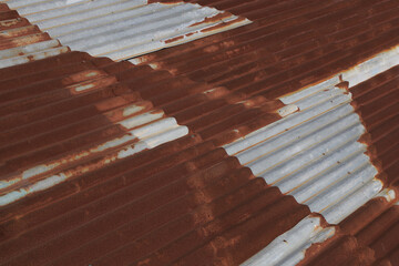 corrugated rusty metal fence, wall, top texture background. rusty zinc sheet wall. Vintage metal sheet roof texture. Pattern of old metal sheet. Rusting metal siding. Corrosion of galvanized texture