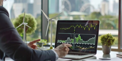 Poster - A dedicated businessman is deeply involved in scrutinizing renewable energy stock data on his laptop, surrounded by wind turbine models, showcasing a commitment to sustainable finance and technology