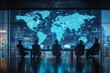 © NurkholisMajid - Silhouetted businesspeople working in a high-rise office with a world map displayed on a screen behind them.