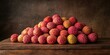 © dekreatif - A pile of fresh lychees on a wooden surface against a brown background.