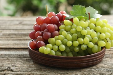 Fresh ripe grapes on wooden table, closeup