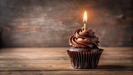 Chocolate cupcake with black frosting and lit candle , cupcake, chocolate, black frosting, candle, celebration, birthday