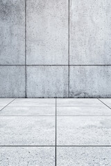 Poster - Modern empty concrete room with a clean textured wall and tiled floor, showcasing minimalist architecture and industrial interior design.