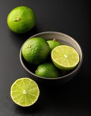 Sticker - Lime in a bowl on a black background