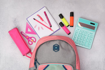 Canvas Print - Flat lay composition with backpack and different school stationery on light grey table