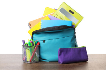 Canvas Print - Backpack with different school stationery on wooden table against white background