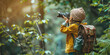 © OleksandrZastrozhnov - Back view of a child taking a photo of wildlife while standing in the forest. Summer kids camp.