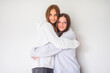© Louis-Paul Photo - Two best girlfriends together on white studio wearing hoodies