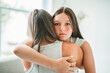 © Louis-Photo - Worried teen with mother consoling share problem with someone close concept