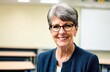 © Julija AI - Senior female teacher smiling in a classroom , highlighting the friendly, engaging atmosphere of the back-to-school season.