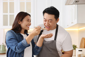 Wall Mural - Happy lovely couple cooking together in kitchen