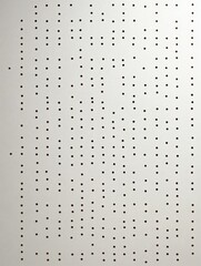 Poster - A minimalist background image featuring a white paper surface with a grid of small black dots, evoking concepts of order, precision, repetition, and simplicity.