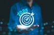 © Supatman - The 2025 new year business goals concept. Businessman hand show goals and targets for the company future growth in 2025. Business plan target strategy, Planning and challenge strategy in new year,