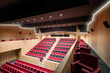 © ADDICTIVE STOCK - Modern auditorium with red seats and wooden panels