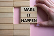 © Natallia - Make it Happen symbol. Concept words Make it Happen on wooden blocks. Beautiful pink background. Businessman hand. Business and Make it Happen concept. Copy space.