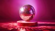 © Tina - A disco ball on a red podium against a pink background with a reflection of light.