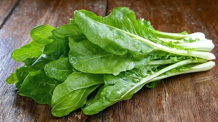 Wall Mural -   A wooden table has a pile of lettuce sitting atop it, alongside a knife