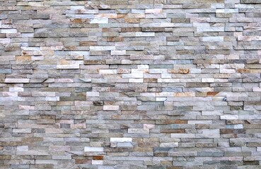 External wall coating made of strip of stones with various colors. Full frame. Background and texture.