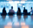 © Natalia - A blurry photo of a group of people sitting at the table. AI.