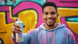© Matthias - Headshot of a graffiti artist wearing a paint-splattered hoodie, holding a spray can