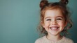 ©  Shomixer - A young child with curly hair styled in two buns wears a knitted sweater, smiling brightly at the camera, capturing the joy and innocence of childhood in a warm portrait.