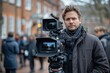 © aicandy - A professional cameraman standing outdoors with a high-definition video camera on a tripod, surrounded by a crowd of people on a busy street