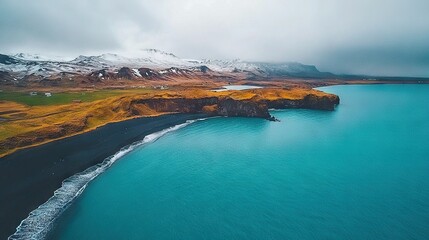 Wall Mural -   A stunning aerial shot of a tranquil body of water surrounded by majestic mountains, including snow-capped peaks in the far distance