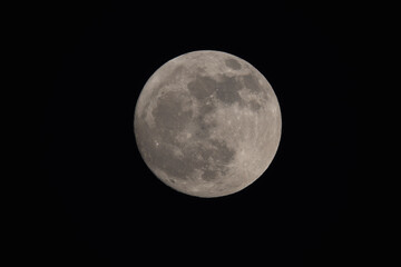 Wall Mural - photograph of the full moon partially covered with clouds