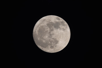 Wall Mural - photograph of the full moon partially covered with clouds