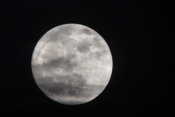 Wall Mural - photograph of the full moon partially covered with clouds