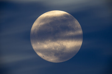 Wall Mural - photograph of the full moon partially covered with clouds