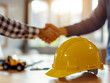 © zphoto83 - A construction handshake symbolizes partnership and commitment to safety at a job site during daylight hours