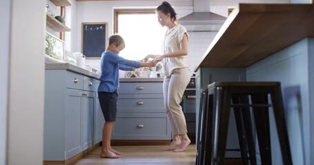 Poster - Mother, child or kitchen for dancing, twirl together or happy bonding on vacation in home. Woman, son and parent care in smile for health wellness, weekend leisure and holiday fun to relax in house