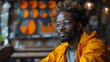 © Linus - A man with glasses and a beard is sitting in a yellow jacket