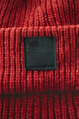 Poster - A red hat with a black label