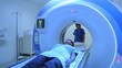 © Felippe Lopes - A patient lies on a table inside a medical imaging machine.