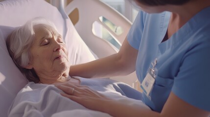 Wall Mural - A young female nurse comforts an elderly woman in a hospital bed.