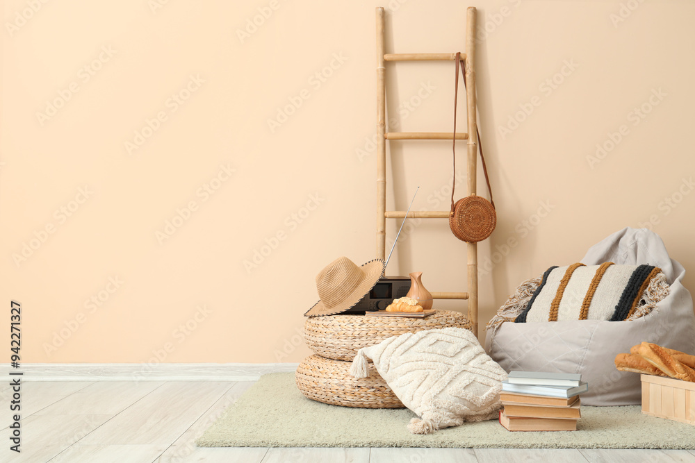 Pouf, cushions and basket with bread near beige wall