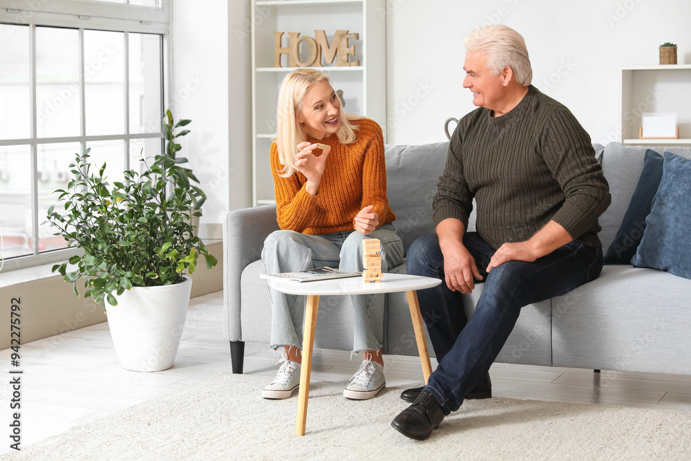 Mature couple playing game at home