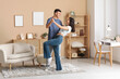 © Pixel-Shot - Happy young couple dancing in living room