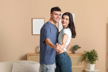 Canvas Print - Happy young couple dancing in living room