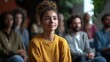 © Narongsag - Young Woman Listening Attentively in a Group Setting
