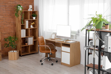 Poster - Interior of modern office with workplace, armchair and shelving units