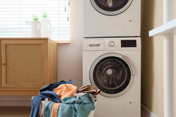 Wall Mural - Basket with clothes near washing machine in laundry room, closeup