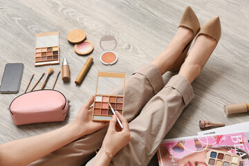 Sticker - Makeup artist with cosmetic products on wooden floor, closeup