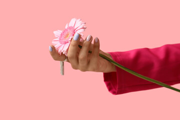 Wall Mural - Female hand with beautiful manicure and gerbera flower on pink background, closeup