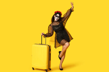 Sticker - Female African-American tourist dressed for Halloween with suitcase on yellow background