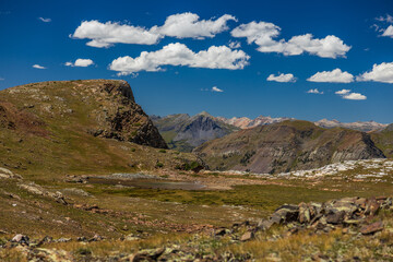 Tundra pool on high altitude plateau with blue skies