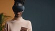 © Shisanupong - A woman wearing a VR headset while holding a smartphone, standing against a dark background, depicting a modern and tech-focused lifestyle..